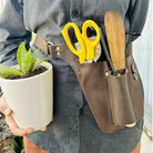 Adjustable leather florist tool belt with deep pockets for pruning shears & floral tools.